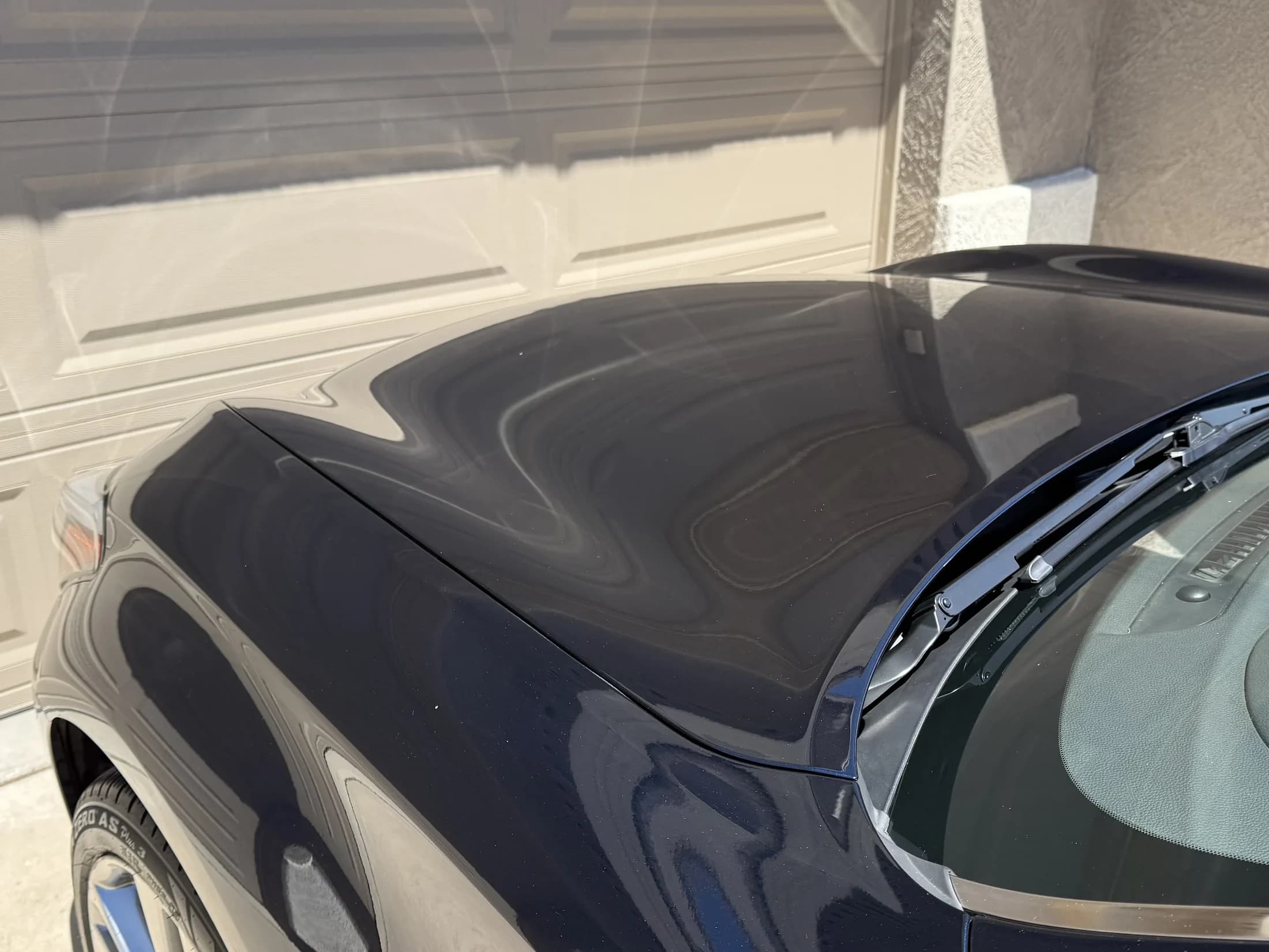 Glossy dark paint reflection after correction.