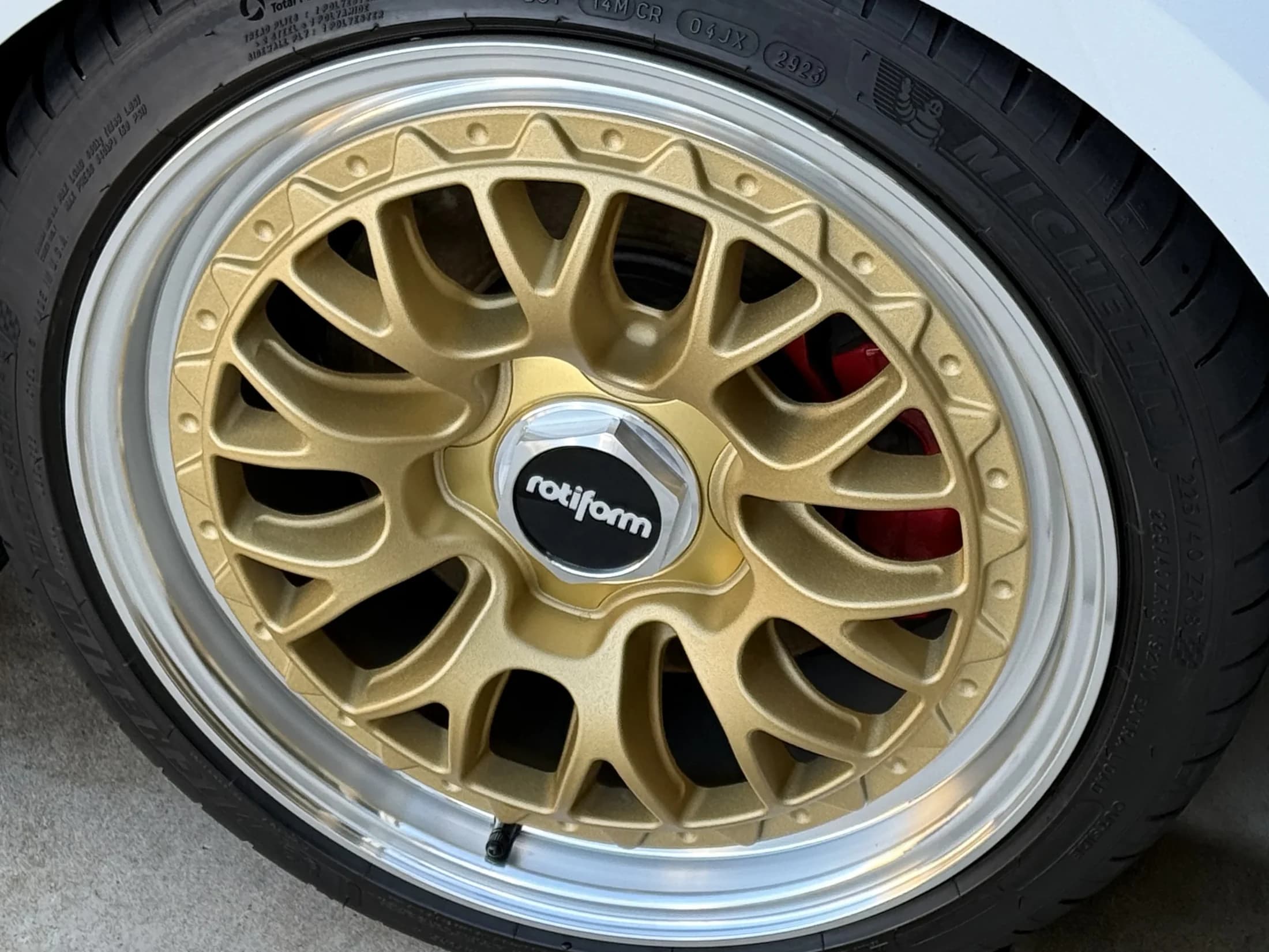 Detailed gold wheel and tire after exterior detailing.