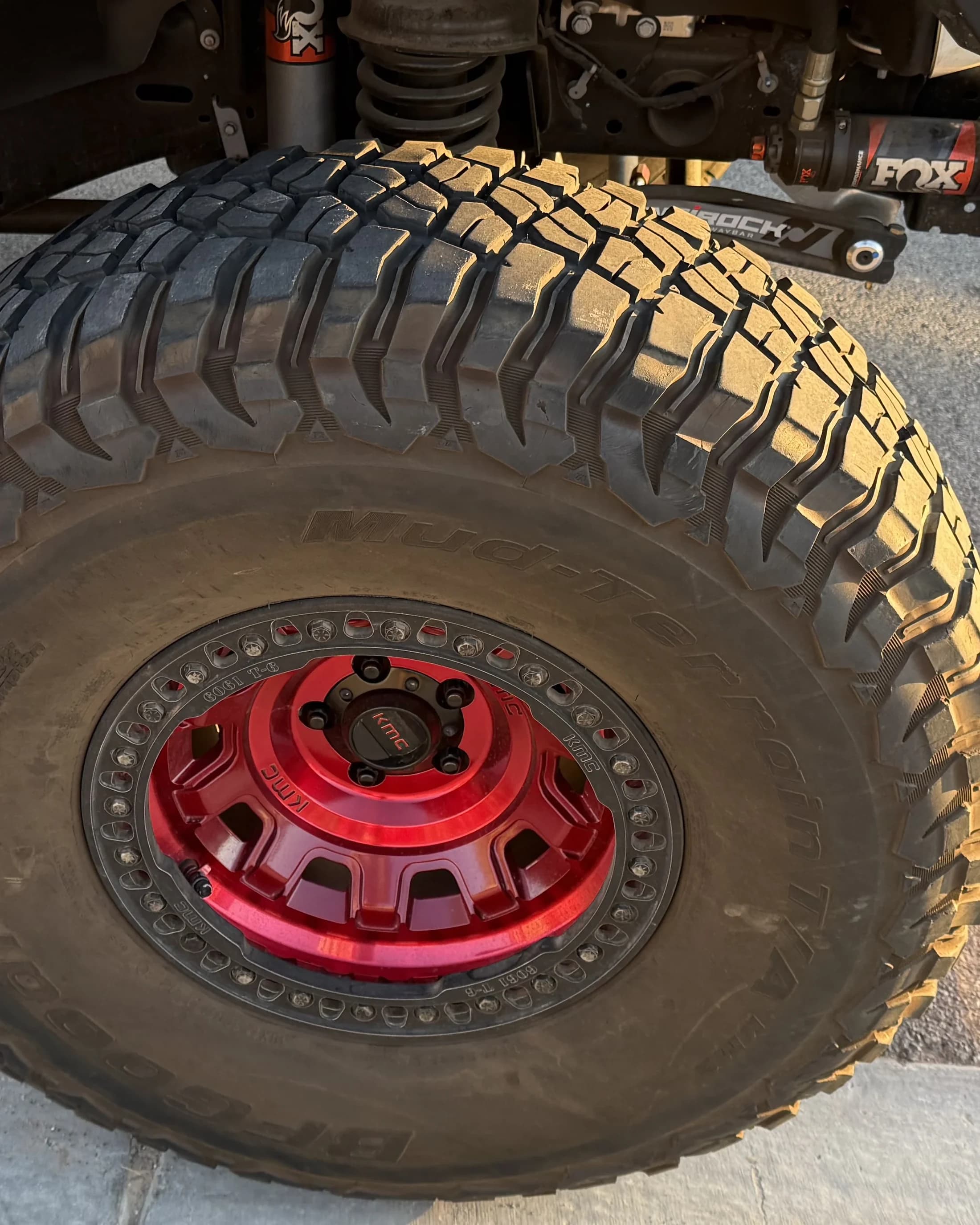 Off-road wheel and suspension detail after cleaning.