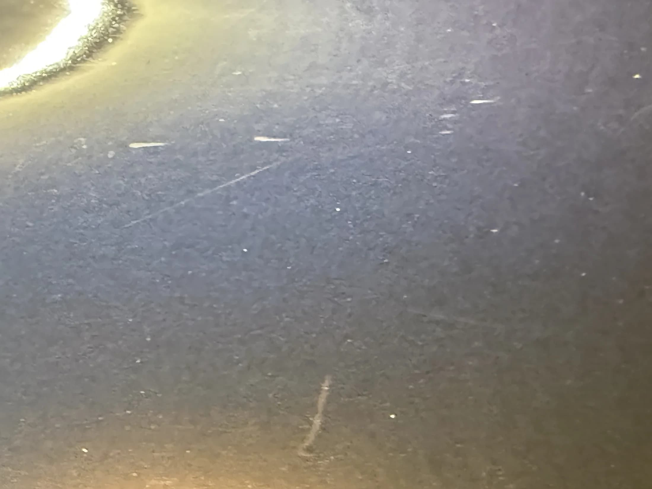 Close inspection of paint surface defects.