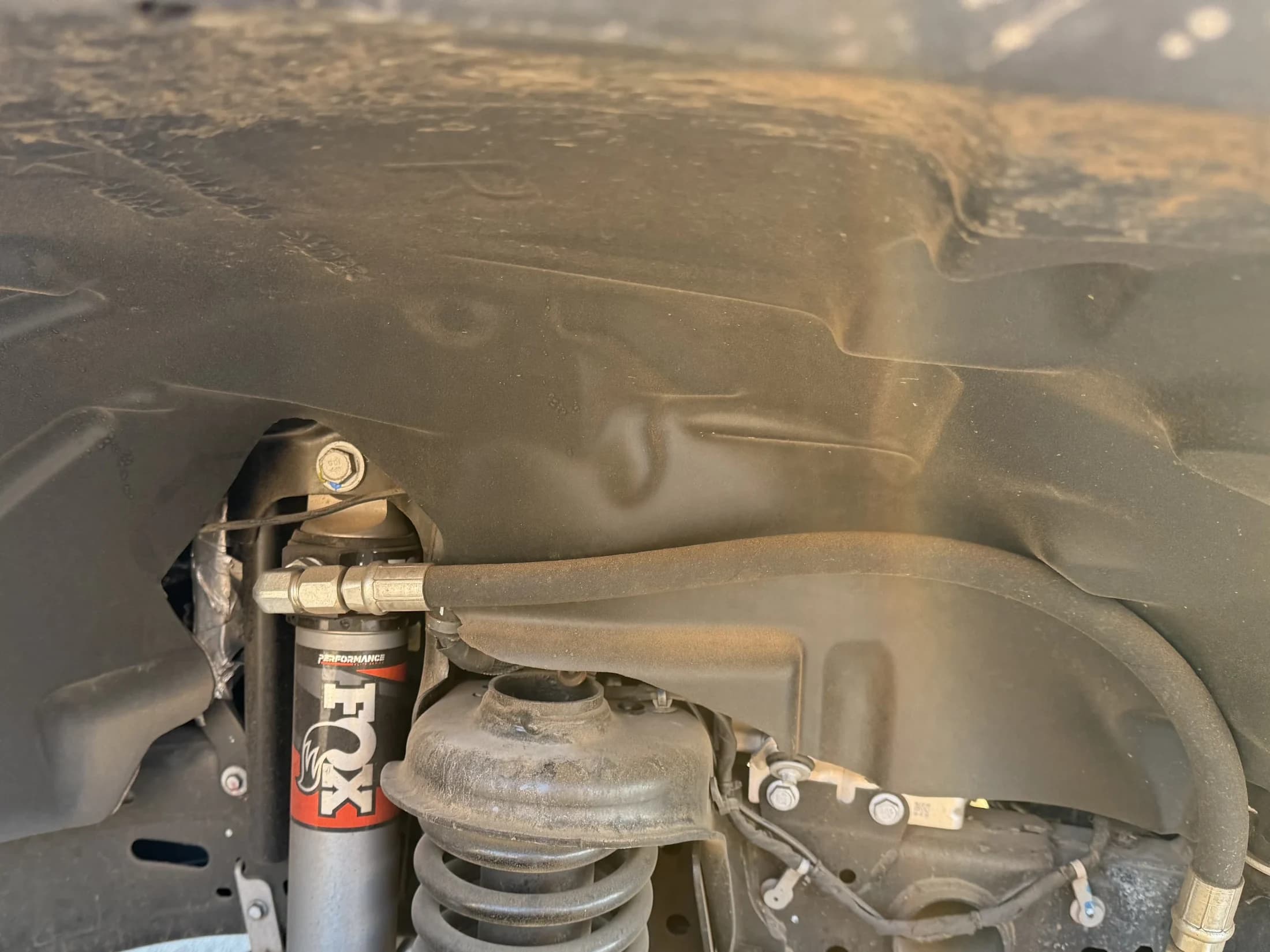 Close view of cleaned suspension and wheel well components.